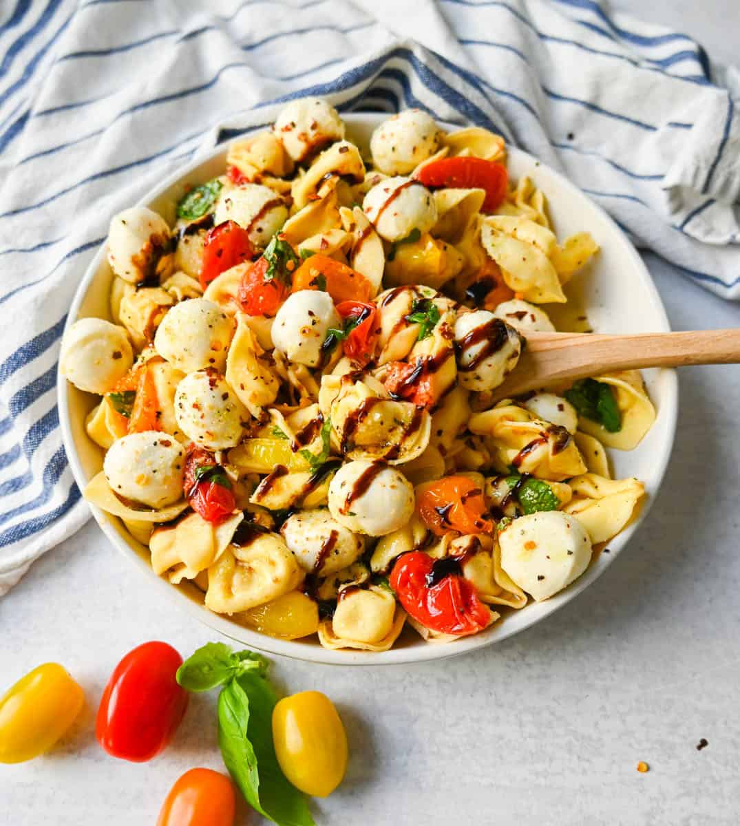 This Caprese Tortellini is made with cheese Tortellini tossed with sauteed garlic and tomatoes in extra virgin olive oil, fresh basil, and fresh mozzarella and spices. This fresh tortellini caprese pasta is perfect for summer!