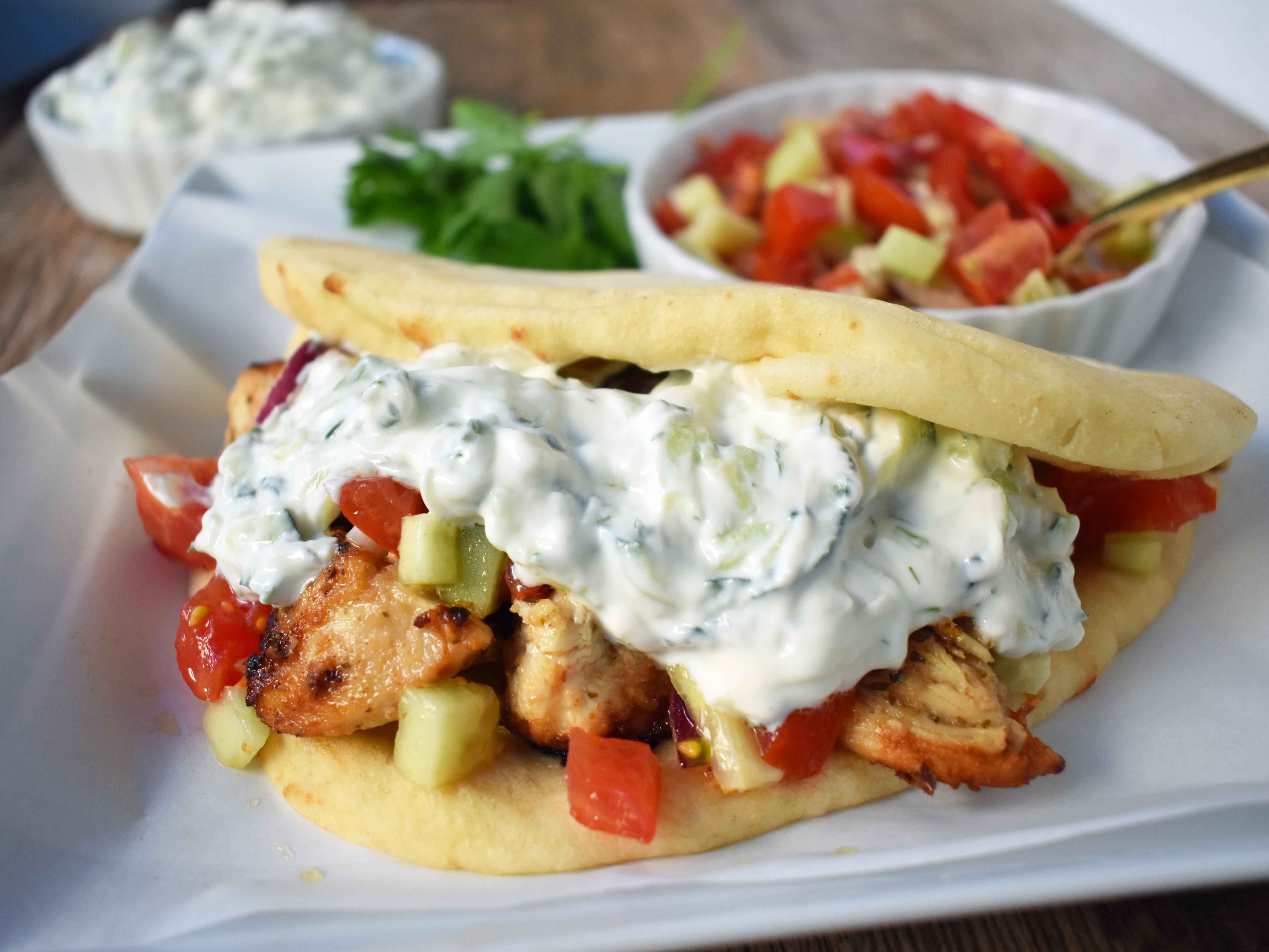 Greek Chicken Gyros with Tzatziki Sauce. Marinated Greek Chicken, grilled to perfection and topped with homemade tzatziki sauce and fresh Greek salad. A healthy and flavorful dish. www.modernhoney.com