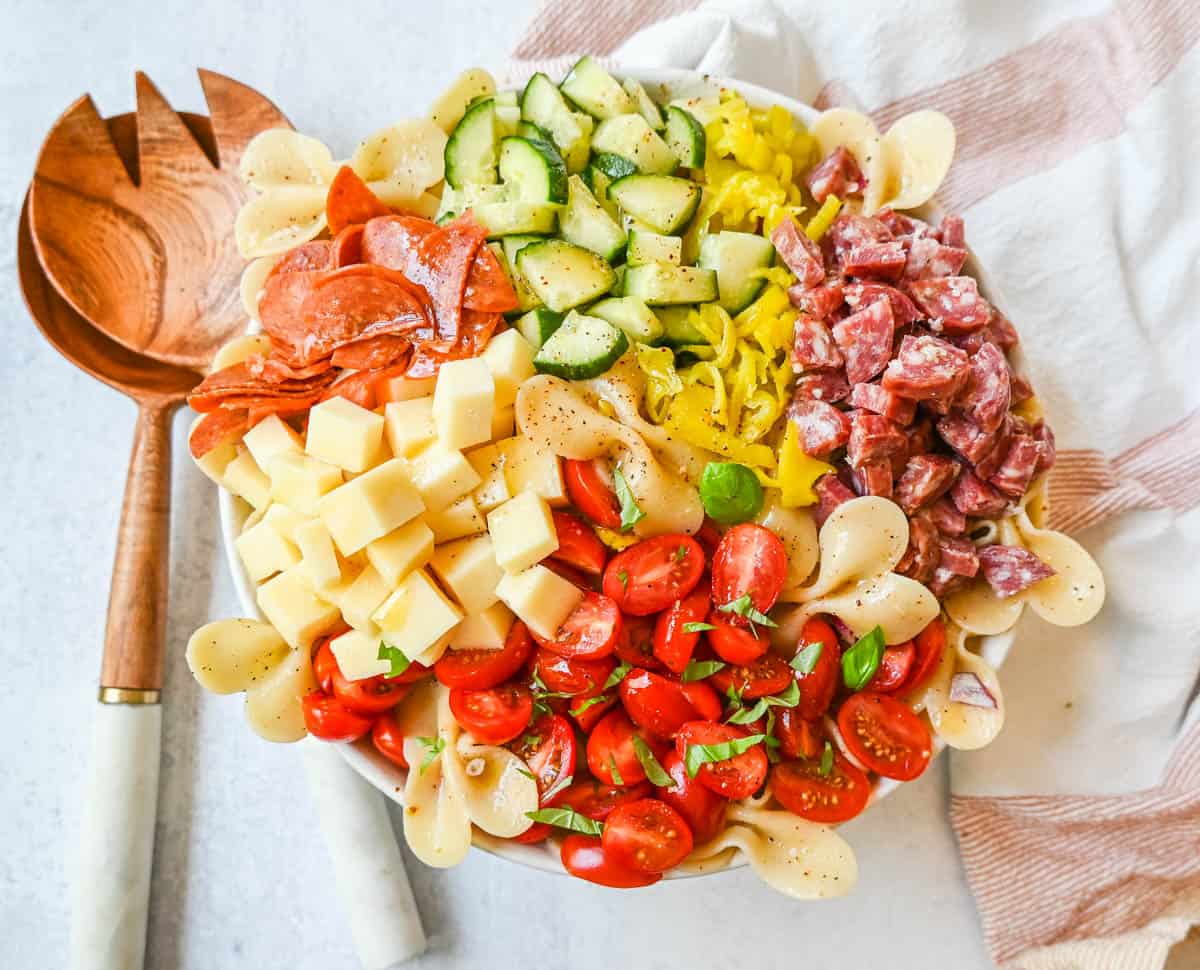 How to make the best pasta salad with Italian meats, cheese, pasta, and vegetables, all tossed with a homemade creamy red wine vinaigrette. This is such an easy, popular pasta salad recipe.