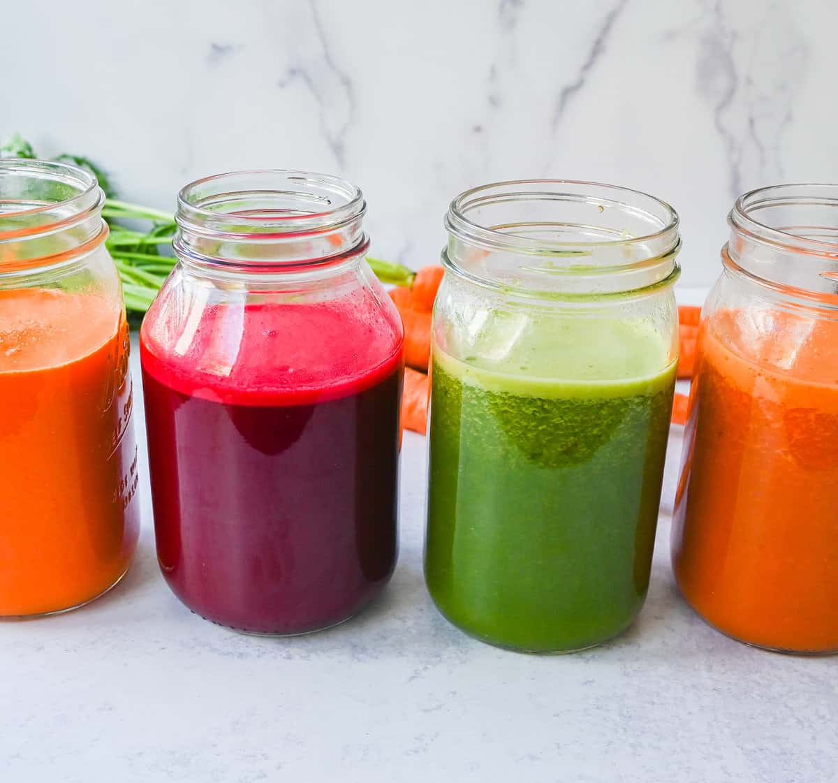 Four healthy juicing recipes to give your body natural energy and helps to detoxify the body! These are the best fresh juice recipes using fresh fruits and vegetables. Get started with juicing with the best juice recipes.