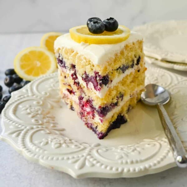 Light, fluffy, moist lemon cake with with fresh blueberries with a sweet cream cheese frosting. This is the best lemon blueberry cake recipe!