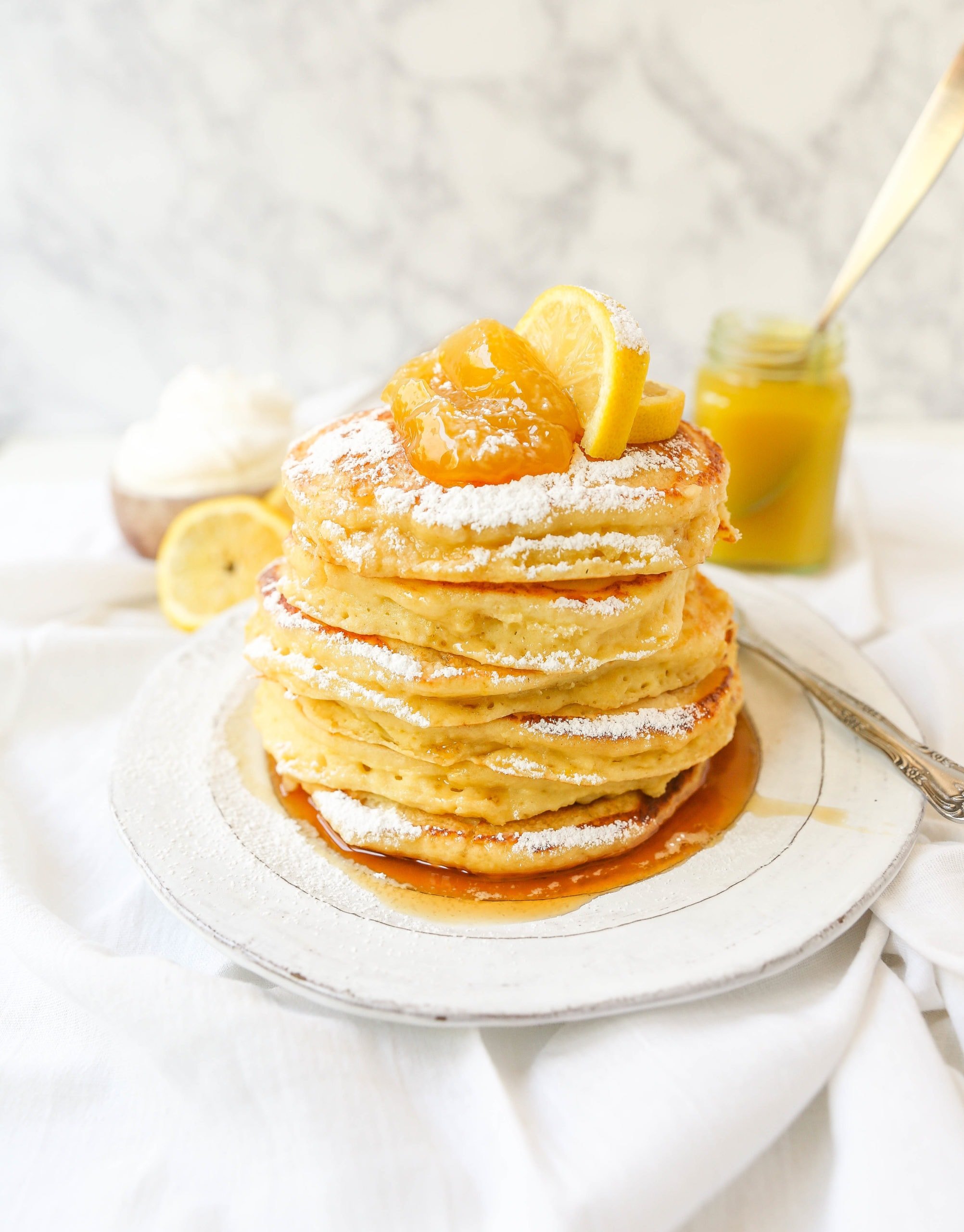 Lemon Ricotta Pancakes Creamy, fluffy lemon ricotta pancakes made with fresh ricotta, buttermilk, fresh lemon zest, and juice. A mix between a pancake and a crepe with a melt-in-your-mouth soft texture. www.modernhoney.com #pancakes #lemonricottapancakes #brunch #breakfast